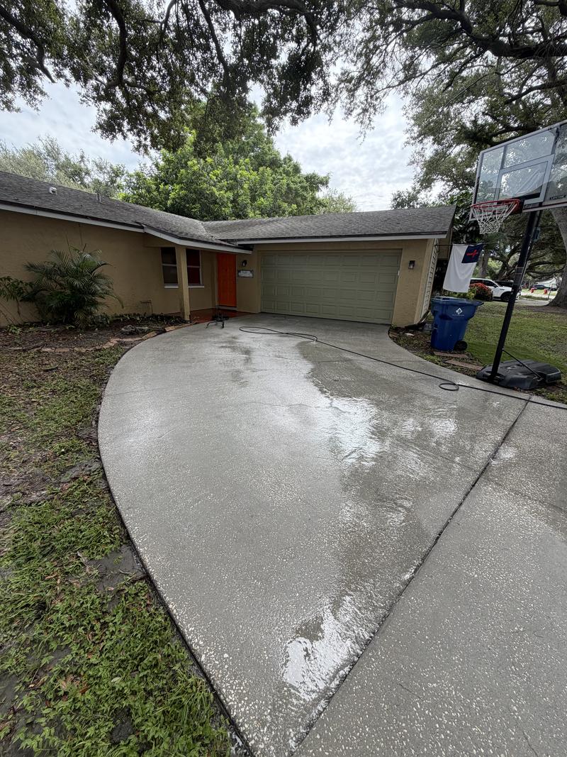 The same driveway after washing, the staining gone and the concrete an even pale grey