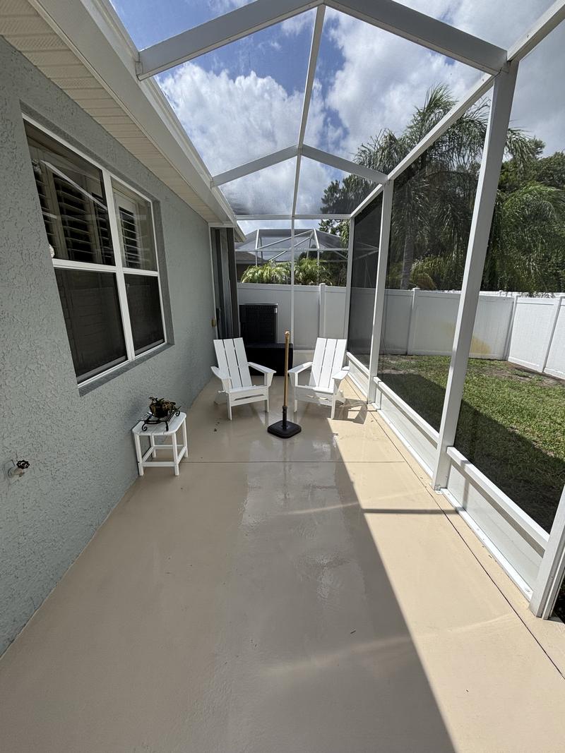 The same lanai floor after soft washing, concrete back to cream
