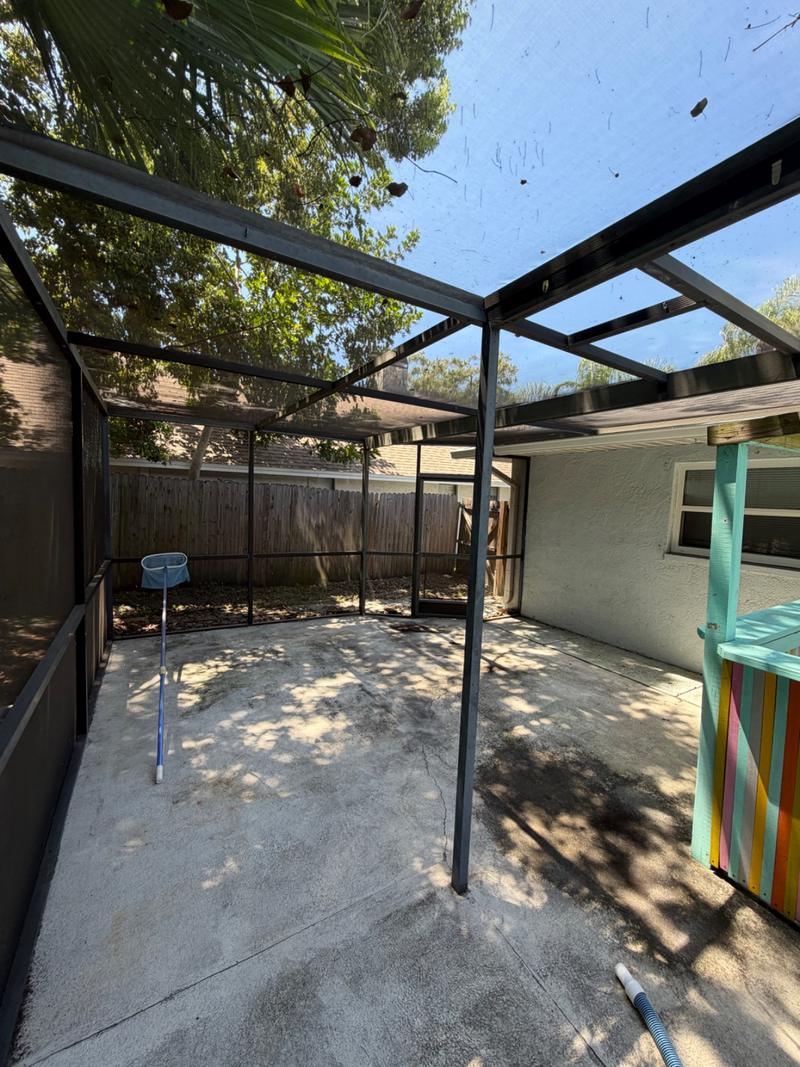 Pool cage screens and deck dulled with dirt before cleaning